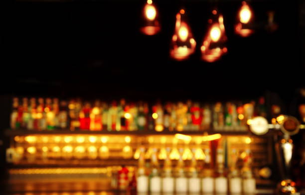 istock blur alcohol bottle drink in bar or pub at night 639535938