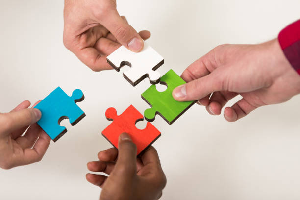 istock business people group assembling jigsaw puzzle and represent team support 639535960