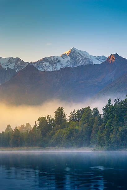 Mount Cook in Lake Matheson New Zealand Mount Cook and Mount Tasman reflected in Lake Matheson at Sunset. New Zealand fox glacier photos stock pictures, royalty-free photos & images