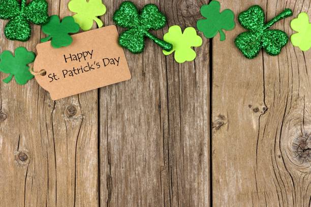 istock St Patricks Day tag with shramrock top border over wood 639536738
