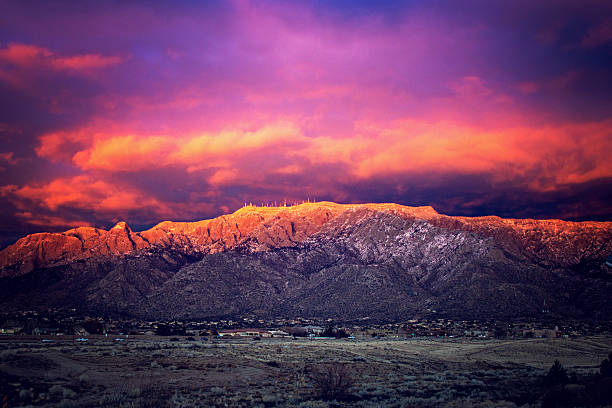 Snow Dusted Sandia Mountains at Magic Hour Southwestern Landscape with Sandia Mountains in New Mexico romantic sky stock pictures, royalty-free photos & images