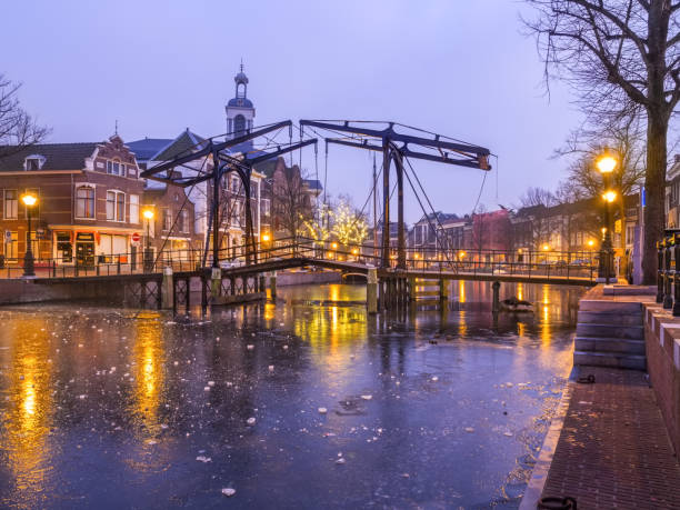 Old Dutch city landscape with freezing canal and bridge stock photo