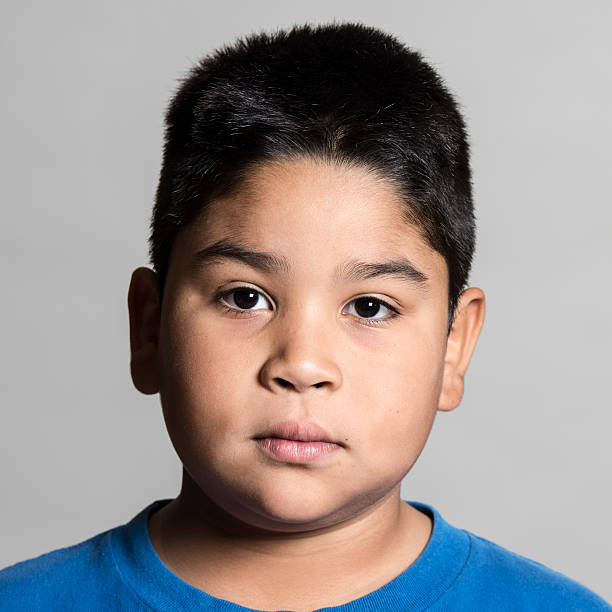 Hispanic or middle eastern ten years old little boy looking at the camera