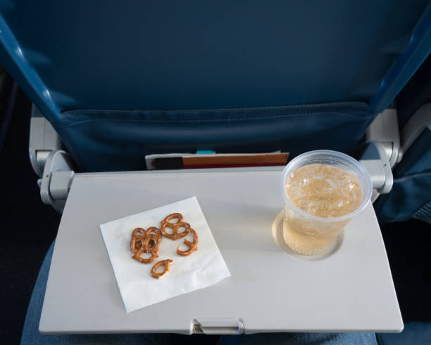 Airline Travel - Economy Class Drink and Snack served in Economy Class on a airplane. airplane food stock pictures, royalty-free photos & images