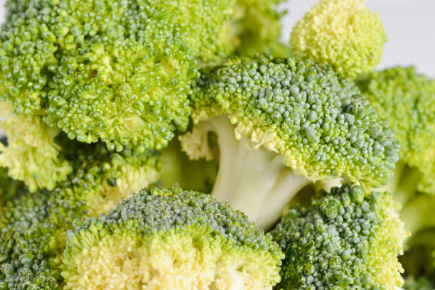 istock Bunch of fresh green broccoli on blue bowl 639543302