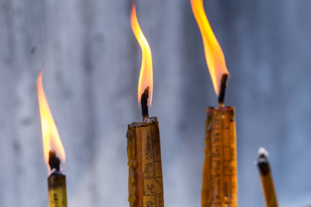 Fire of peace, Buddhist pray and respect Buddha with candle in Thailand temple