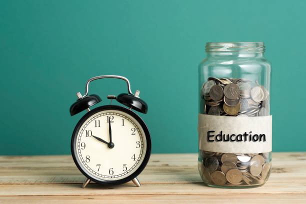 istock Alarm Clock with Coins Jar - Business Concept 639546478