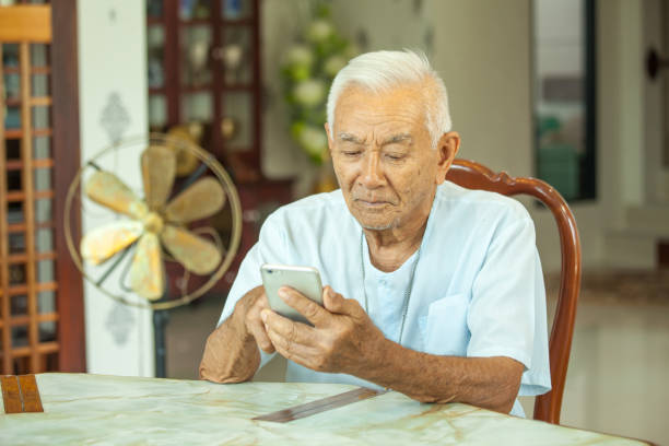 istock Happy asian senior man using the mobile phone at home 639547728