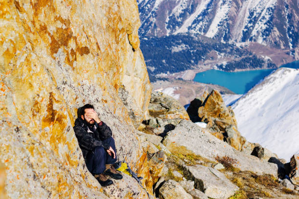 A rockclimber's hand on the final ledge.