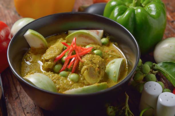 istock Thai chicken green curry with old wooden background 639549664