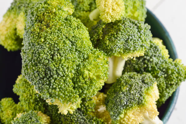 istock Bunch of fresh green broccoli on blue bowl 639549784