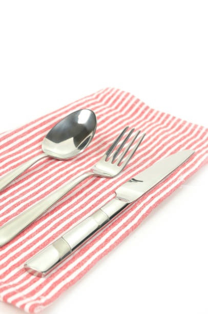 istock Stainless tableware set, spoon fork knife lay no red napkin 639550448