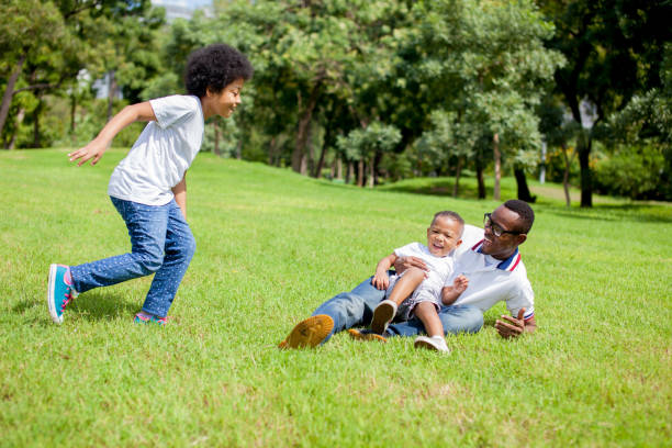 istock Two kids chasing and playing together while dad caught boy 639552318