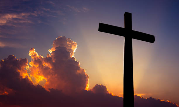 istock Christian cross over beautiful sunset background 639553824
