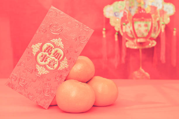 istock mandarin oranges with Chinese new year red packets 639553876