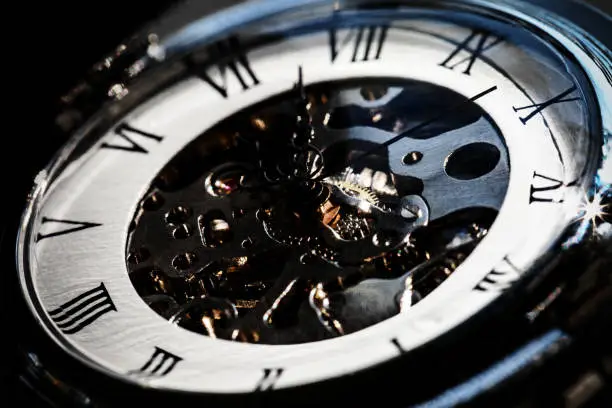 Close-Up of Luxury vintage mechanical watch with visible mechanism., In dark tone.