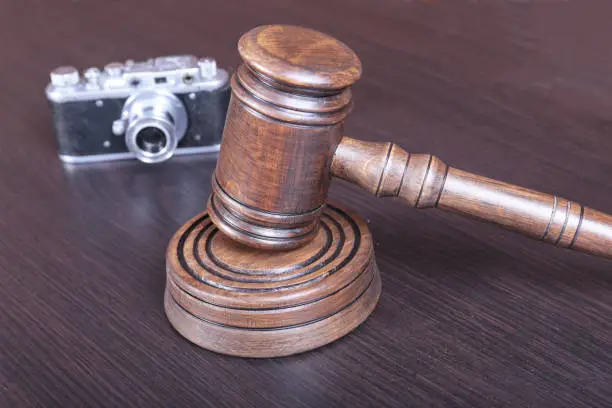 auction hammer , symbol of authority and vintage camera.