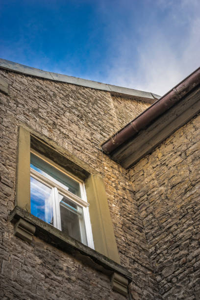 istock Corner of a historical house with windows and gutter 639558568