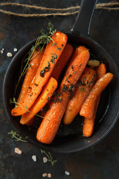 istock Baked carrots with heavy frying pan on rustic background 639558604