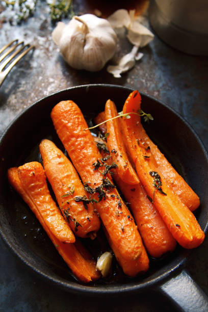istock Baked carrots with heavy frying pan on rustic background 639558814