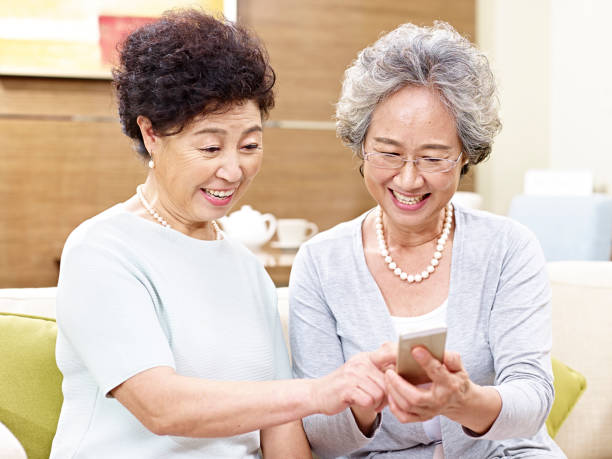 istock senior asian women using mobile phone 639558994