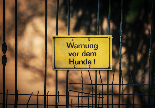 German warning sign hanging on the fence