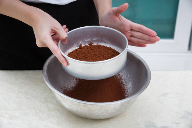 sifting cocoa powder stock photo
