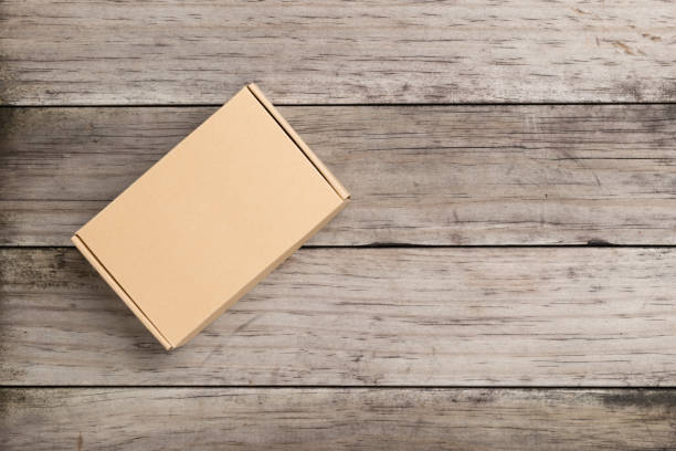 istock Cardboard box on a  wooden background 639561766
