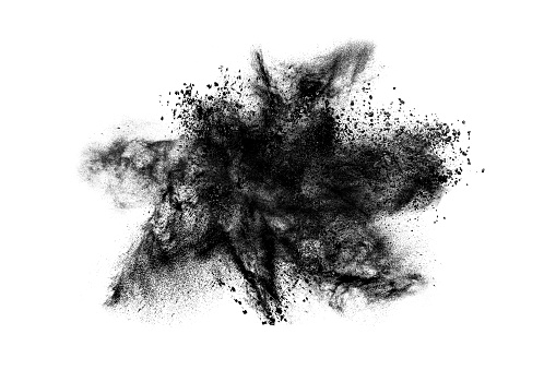 Abstract exploding black powder isolated on white background.
