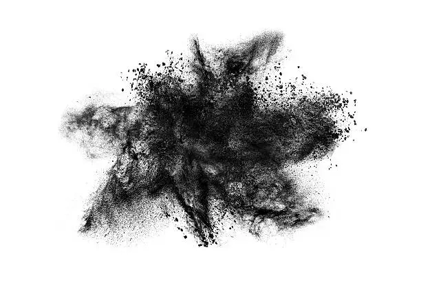 Abstract exploding black powder isolated on white background.