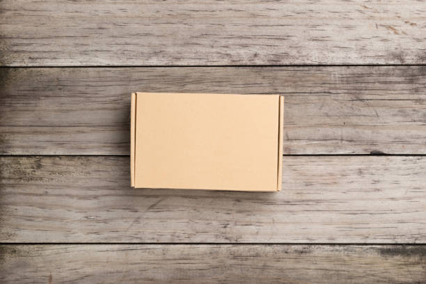 istock Cardboard box on a  wooden background 639561926