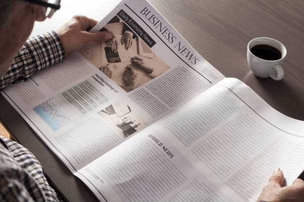 istock Senior man reading newspaper on table 639565836