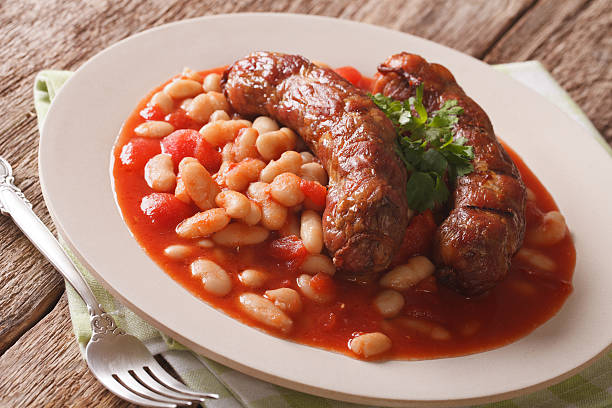 istock Grilled sausage with beans in tomato sauce on a plate 639567266