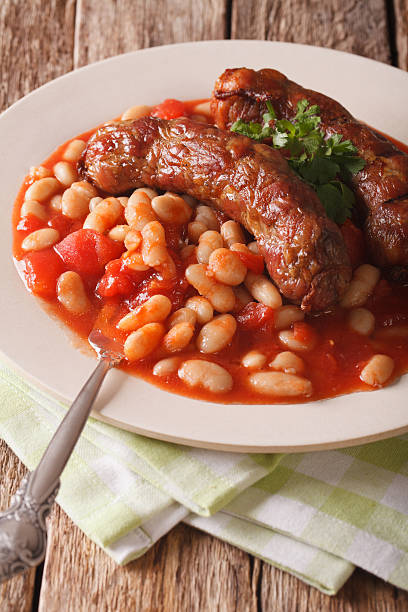 istock Grilled sausage with beans in tomato sauce on a plate 639567506