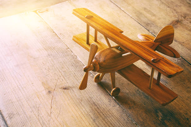 image of vintage old toy airplane over old table. Filtered image