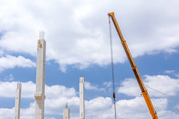 istock Mobile crane beam is assembly concrete skeleton against blue clo 639569462
