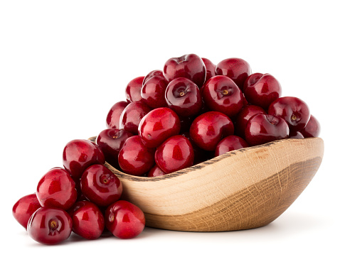 High angle view of a plate full of cherries on white background