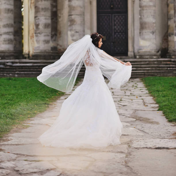 istock brunette bride wearing white dress 639573650