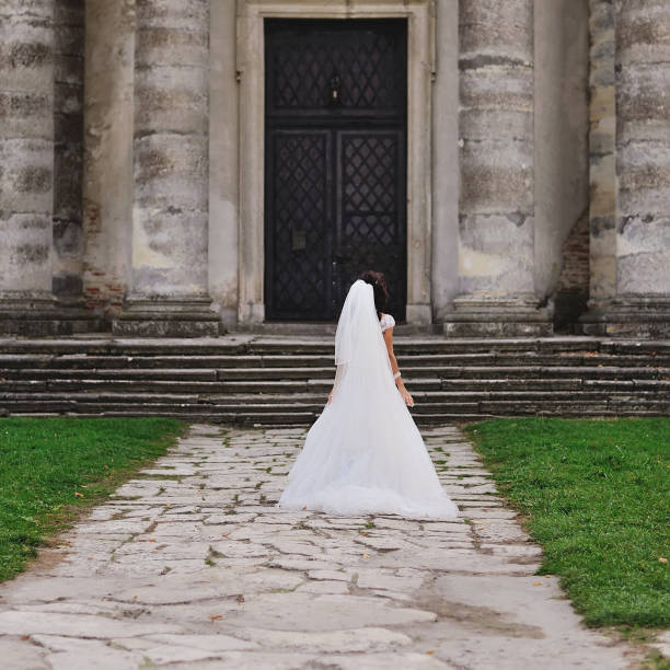 istock brunette bride wearing white dress 639573720