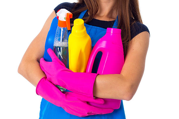 istock Woman in apron holding a detergents 639579108