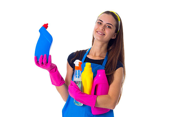 istock Woman in apron holding a detergents 639579464
