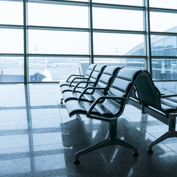 istock empty airport terminal waiting area with chairs 639580860