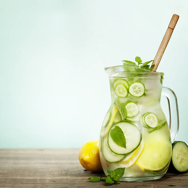 Infused water with cucumber, lemon, lime and mint stock photo