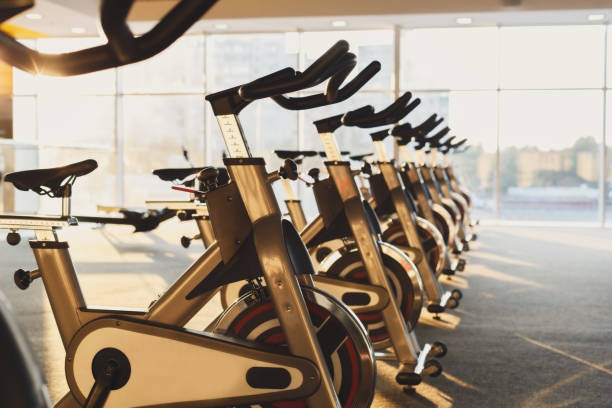 istock Modern gym interior with equipment, fitness exercise bikes 639580982