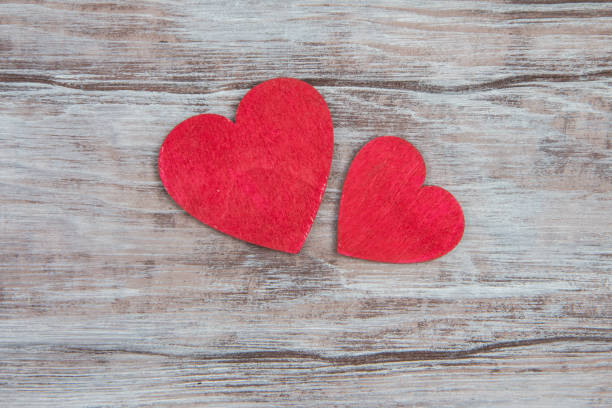istock Two red wooden heart on gray rustic table 639581064