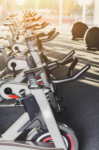 istock Modern gym interior with equipment, fitness exercise bikes handlebars 639582812