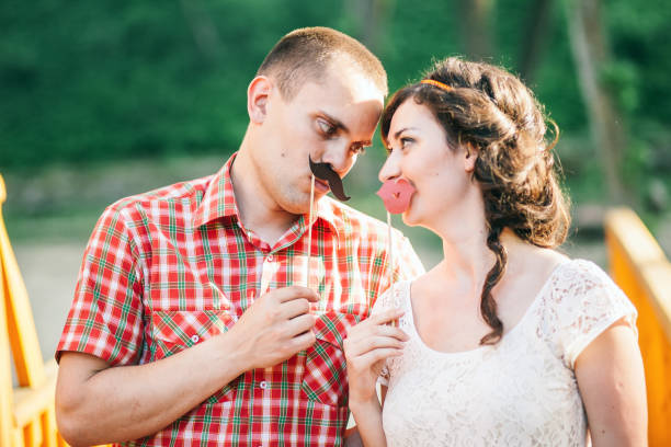 istock couple with paper moustache 639583010