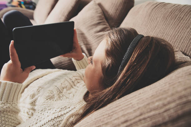 istock Happy little girl with digital tablet 639583178