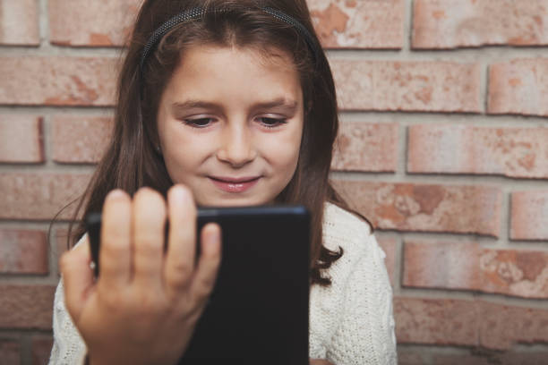 istock Happy little girl with digital tablet 639583448