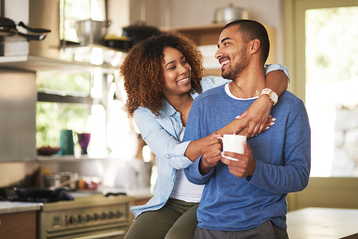 Shot of a happy young couple feeling relaxed in the at home